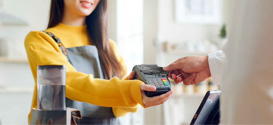 Customer using tap-to-pay with Taz Visa credit card.